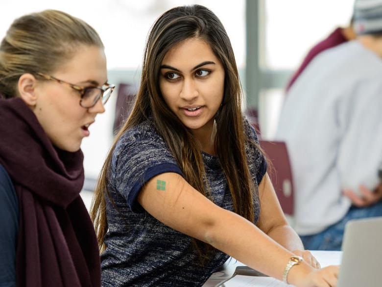 A student helping another student.